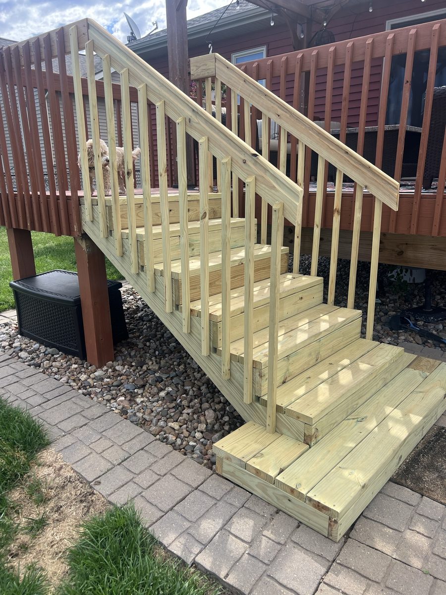 Rebuilt deck stairs side view, fresh pine treads and stringers