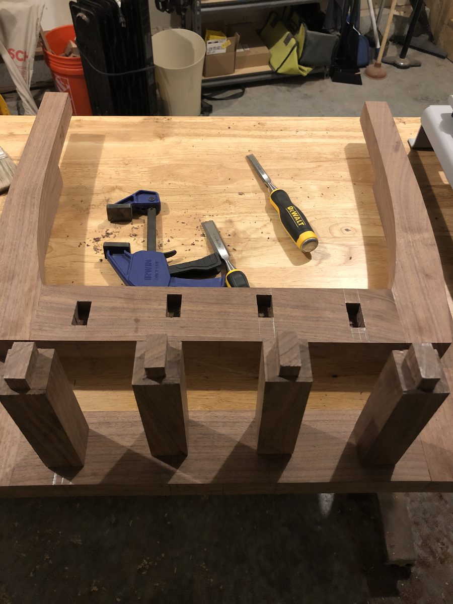 Black walnut end-table leg-and-lattice base during the build, showing open mortises