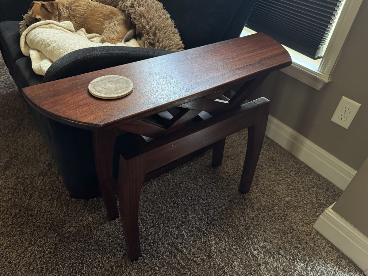 Black walnut demilune end table in place beside the couch