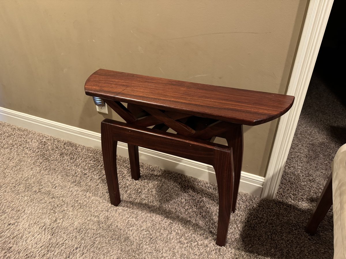 Hand-built black walnut demilune end table with angled lattice support